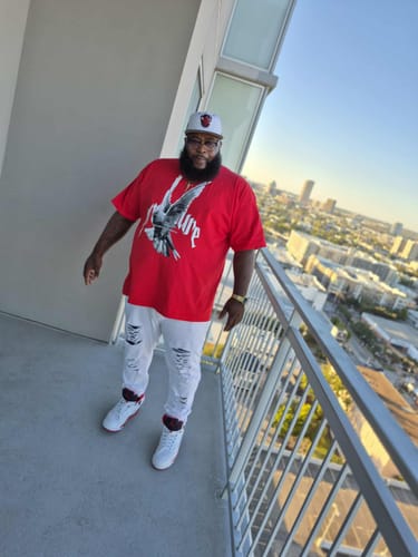 Red tee, white 1s, downtown view