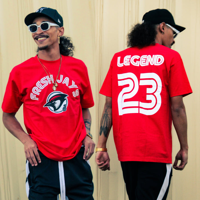Red t-shirt with black, white, and red jay with white fresh jays text on front and legend 23 text on back.