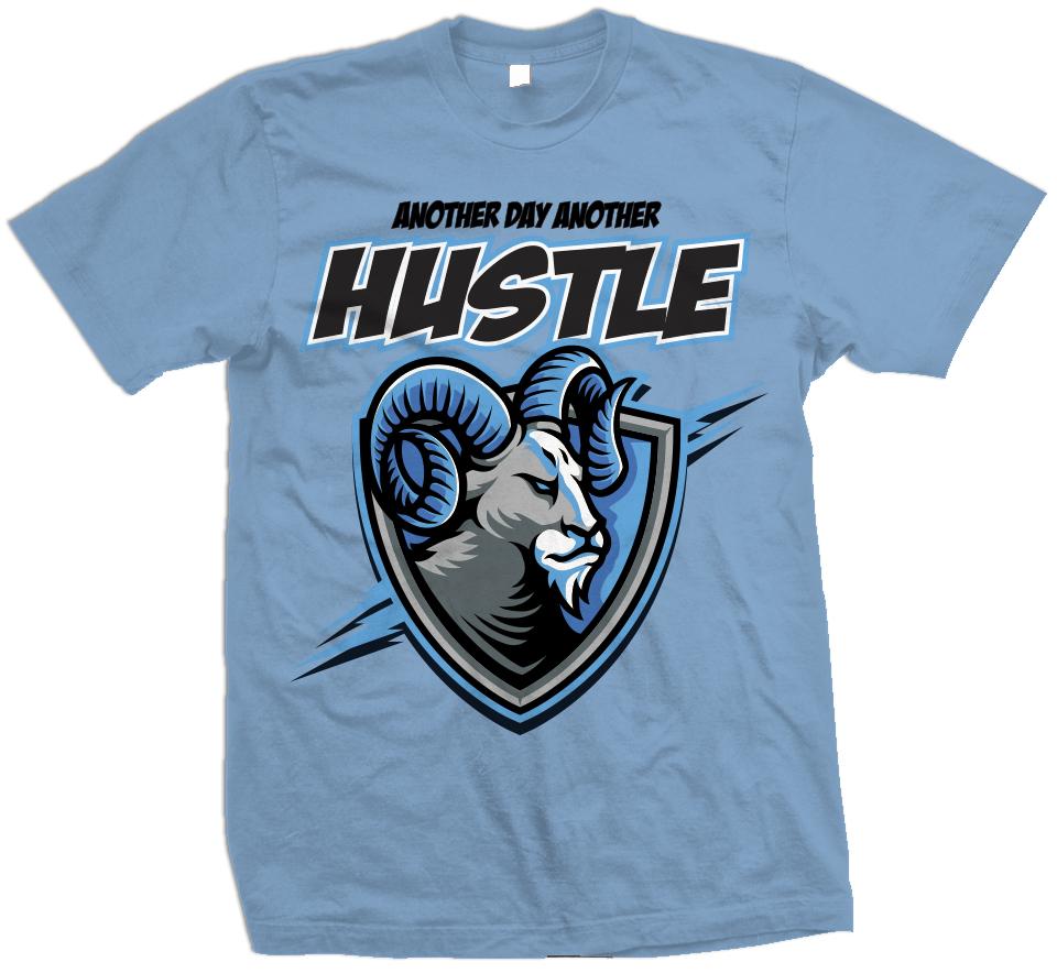 UNC University blue t-shirt with grey, white, black, and blue ram in shield.  Black and white another day another hustle text.