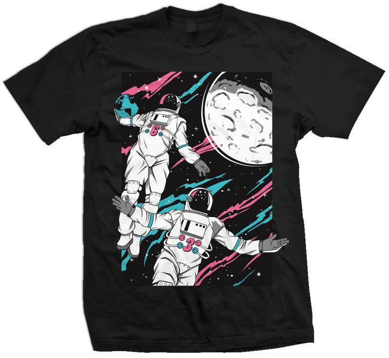 Black t-shirt with white, pink, and aqua blue astronauts alley-ooping to the moon on black background.