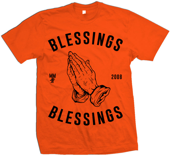Orange T-shirt with black prayer hands. Black MM, 2008, and blessings on blessings text. text.