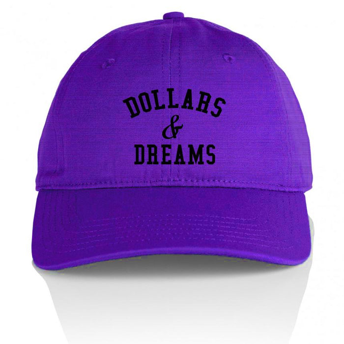 Purple dad hat with black dollars & dreams text.