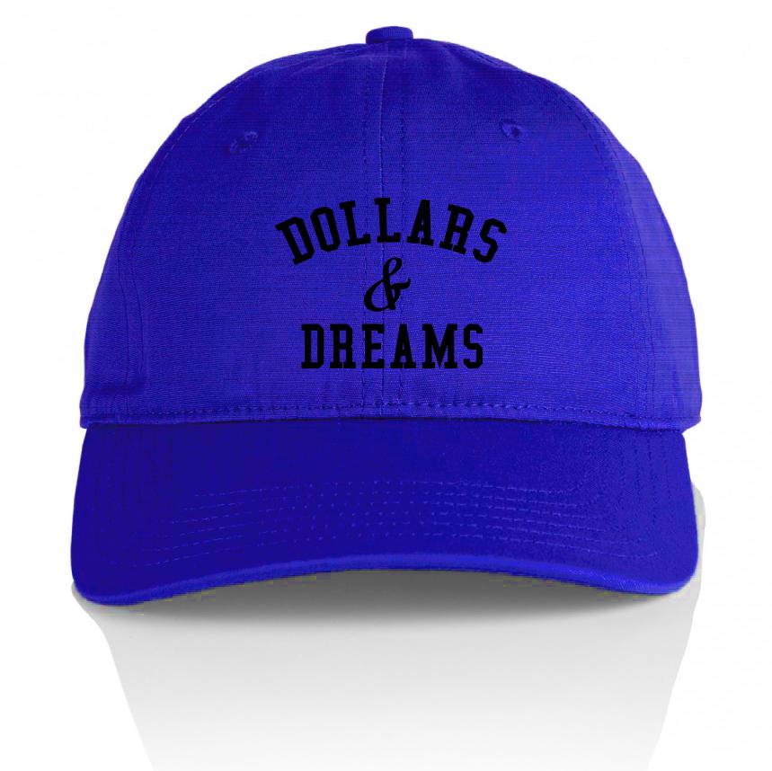Royal blue dad hat with black million dolla motive text on front and dollars & dreams text on back.