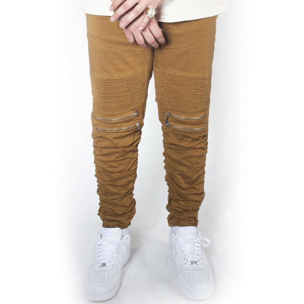 Dark wheat twill jogger pants with gold zippers and jordans.