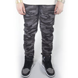 Black and grey camoflauge-colored twill jogger pants with jordans.