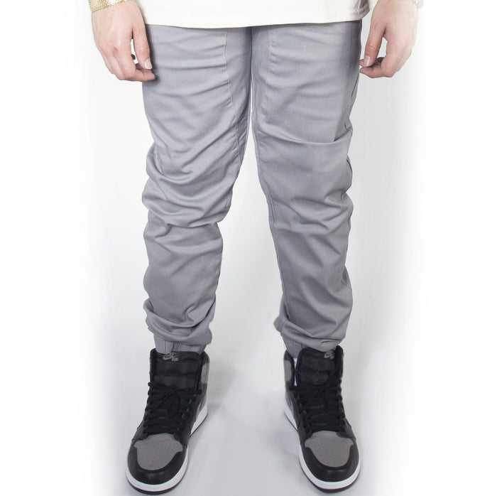 Light grey twill jogger pants with jordans.