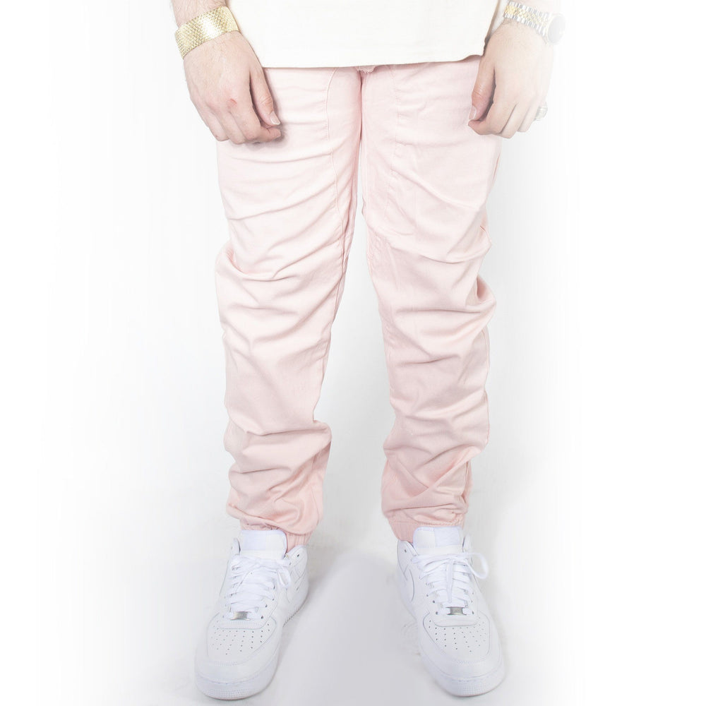 Pink twill jogger pants with jordans.